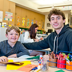 Two students smiling. Links to Gifts of Appreciated Securities securities.jpg