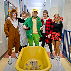 A group of students with their teacher. Links to What to Give