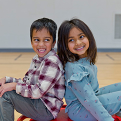 Two students smiling. Links to Beneficiary Designations